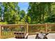 Relaxing deck with chairs overlooking the serene pond and lush trees at 522 Trabert Nw Ave, Atlanta, GA 30309