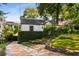 Inviting front exterior with a stone pathway, manicured lawn, and mature trees providing shade at 522 Trabert Nw Ave, Atlanta, GA 30309