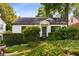 Charming home with manicured front yard, trimmed hedges, and gray front door at 522 Trabert Nw Ave, Atlanta, GA 30309