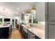 Modern kitchen featuring a farmhouse sink, custom cabinets, stone countertops, and stainless steel appliances at 522 Trabert Nw Ave, Atlanta, GA 30309