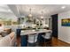 Charming kitchen island featuring bar seating, stone countertops, and open layout to the living area at 522 Trabert Nw Ave, Atlanta, GA 30309