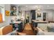 Elegant kitchen with stainless appliances, open shelves, and stone countertops flowing into the dining and living spaces at 522 Trabert Nw Ave, Atlanta, GA 30309