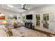 Bright living room with ample seating, white interior, hardwood floors, and glass doors to the screened porch at 522 Trabert Nw Ave, Atlanta, GA 30309