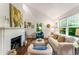 Bright and airy living room featuring fireplace, hardwood floors and multiple windows at 522 Trabert Nw Ave, Atlanta, GA 30309