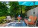 Cozy patio with seating, umbrella, landscaping and a fountain with a water feature at 522 Trabert Nw Ave, Atlanta, GA 30309