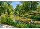 Picturesque pond surrounded by vibrant greenery and mature trees at 522 Trabert Nw Ave, Atlanta, GA 30309