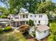 Aerial view of the home's rear exterior, showcasing a screened porch, detached garage, and lush backyard at 522 Trabert Nw Ave, Atlanta, GA 30309