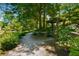 Tranquil walking path by the pond, featuring a pergola and beautiful landscaping at 522 Trabert Nw Ave, Atlanta, GA 30309