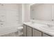 Bathroom featuring double vanity, large mirror, shower, tub, and toilet at 605 Lobelia Way, Locust Grove, GA 30248