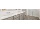 Bathroom featuring double sink vanity with countertop, neutral cabinets, and glass enclosed shower at 605 Lobelia Way, Locust Grove, GA 30248