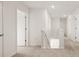 Bright hallway featuring neutral carpet, white walls, and access to multiple rooms at 605 Lobelia Way, Locust Grove, GA 30248