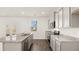 Modern kitchen featuring grey cabinets, granite countertops, stainless steel appliances, and a kitchen island at 605 Lobelia Way, Locust Grove, GA 30248