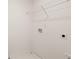 Small laundry room with white walls, wire shelving, and utility connections at 605 Lobelia Way, Locust Grove, GA 30248