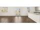 Living room with hardwood flooring, French doors, and a view into the kitchen at 605 Lobelia Way, Locust Grove, GA 30248