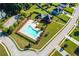 Aerial view of a home with a pool, manicured lawn, and well-maintained landscaping in a suburban neighborhood at 191 Kyndal Dr, Hampton, GA 30228