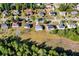 Aerial view showcasing residential neighborhood homes with tree coverage and proximity to power lines at 191 Kyndal Dr, Hampton, GA 30228