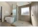 Bright bathroom showcasing a modern shower with gray tiling and soaking tub at 191 Kyndal Dr, Hampton, GA 30228
