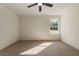 Spacious bedroom with neutral carpet, large window, and ceiling fan at 191 Kyndal Dr, Hampton, GA 30228