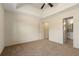 Bright bedroom with carpet floors, a ceiling fan, and an ensuite bathroom at 191 Kyndal Dr, Hampton, GA 30228