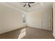 Spacious bedroom featuring plush carpet, neutral walls, a ceiling fan, and a window letting in natural light at 191 Kyndal Dr, Hampton, GA 30228