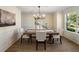 Elegant dining room featuring modern lighting, classic wainscoting, and ample natural light at 191 Kyndal Dr, Hampton, GA 30228