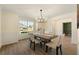 Charming dining area with modern lighting, wainscoting, and a large window, creating a welcoming space at 191 Kyndal Dr, Hampton, GA 30228