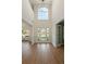 Grand foyer with high ceilings, a large window, and sleek hardwood flooring, creating an elegant entrance at 191 Kyndal Dr, Hampton, GA 30228
