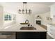 Modern kitchen with island, stainless steel appliances, and view into living room at 191 Kyndal Dr, Hampton, GA 30228