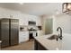 Bright kitchen featuring white cabinets, stainless appliances, and quartz countertops at 191 Kyndal Dr, Hampton, GA 30228