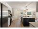 Modern kitchen with stainless steel appliances and an island with black cabinets at 191 Kyndal Dr, Hampton, GA 30228