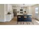 Kitchen with black island, white cabinets, stainless appliances, and breakfast bar at 191 Kyndal Dr, Hampton, GA 30228