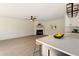 Open concept living room with fireplace and view into kitchen with breakfast bar at 191 Kyndal Dr, Hampton, GA 30228