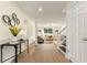 Spacious hallway leading to a bright living room with stylish decor and easy access to the staircase at 191 Kyndal Dr, Hampton, GA 30228