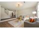 Bright living room with modern light fixture, wood floors, and stylish decor at 191 Kyndal Dr, Hampton, GA 30228