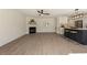 Open concept living room with fireplace and view into kitchen with breakfast bar at 191 Kyndal Dr, Hampton, GA 30228
