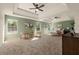 Expansive main bedroom with tray ceilings, ample natural light, and a seating area at 191 Kyndal Dr, Hampton, GA 30228
