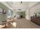 Spacious main bedroom with tray ceilings and windows, featuring natural light and comfortable seating at 191 Kyndal Dr, Hampton, GA 30228
