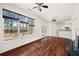 Sunlit room with hardwood floors, large windows, and a ceiling fan at 2890 Winterhaven Ct, Atlanta, GA 30360
