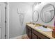 Bright bathroom featuring double sinks, round mirrors, and modern decor at 468 Lake Ridge Ln, Fairburn, GA 30213