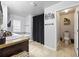 Bright bathroom with dual sinks, a soaking tub, and a separate toilet room at 468 Lake Ridge Ln, Fairburn, GA 30213