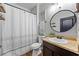 Well-lit bathroom featuring a shower with white and black curtain and modern decor at 468 Lake Ridge Ln, Fairburn, GA 30213