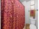 Bathroom area showcasing a vibrant shower curtain and toilet at 468 Lake Ridge Ln, Fairburn, GA 30213