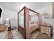 Charming bedroom with a wooden canopy bed, decorative pillows, and natural light at 468 Lake Ridge Ln, Fairburn, GA 30213