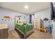 A cheerful bedroom with blue walls and fun dinosaur decor at 468 Lake Ridge Ln, Fairburn, GA 30213