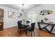 Cozy dining area filled with modern lighting fixtures and hardwood floors at 468 Lake Ridge Ln, Fairburn, GA 30213