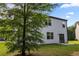 Rear view of the house with a large tree in the backyard at 468 Lake Ridge Ln, Fairburn, GA 30213