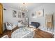 Bright living room featuring art, a modern light fixture, and comfortable seating at 468 Lake Ridge Ln, Fairburn, GA 30213