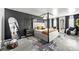 Spacious main bedroom suite with a four-poster bed, stylish decor, and cozy seating area at 468 Lake Ridge Ln, Fairburn, GA 30213
