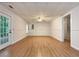 Spacious basement featuring hardwood floors, ceiling fan, and a door leading to the outside at 6001 Deer Springs Nw Ln, Acworth, GA 30101