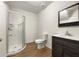 Bathroom featuring a glass walk-in shower, toilet, and dark wooden vanity with a light countertop at 6001 Deer Springs Nw Ln, Acworth, GA 30101
